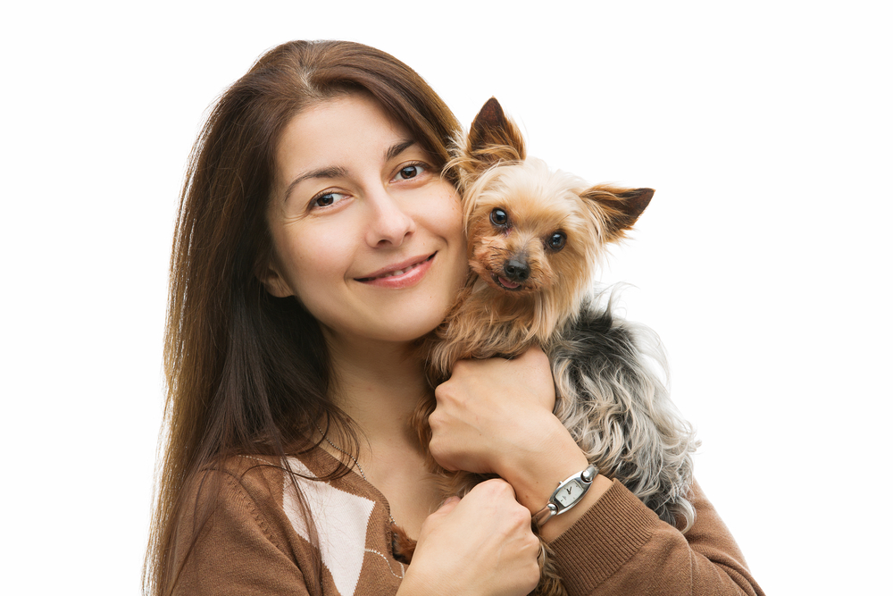 young woman cuddling yorkie